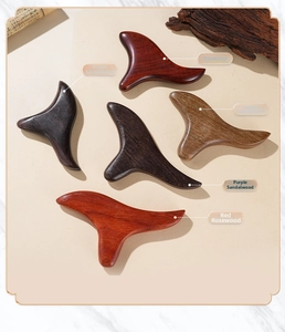 Various sandalwood massage tools with natural wood grain texture and smooth edges