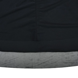 Detail shot of black knitted dress hem featuring a mesh layer and refined stitching