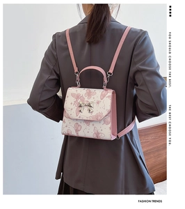 Detail of pink and white butterfly pattern backpack shown on a model's back