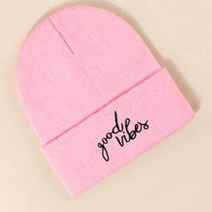 Detailed close-up of pink ribbed beanie featuring black good vibes embroidery on the cuff