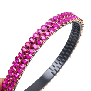 Close-up of pink teardrop rhinestones on a gold setting Baroque headband