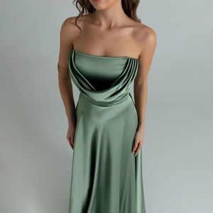 Detailed close-up of elegant green satin evening dress featuring draped pleats at the neckline