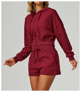 Detail of soft burgundy zip-up hoodie set with ribbed cuffs and adjustable drawstring