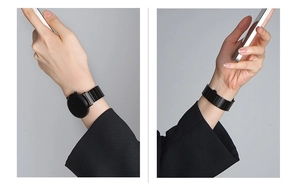 Detail of a sleek black stainless steel link band on a smartwatch worn on wrist
