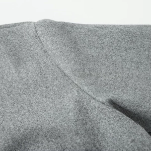 Close-up of premium gray wool fabric texture and fine stitching on autumn jacket