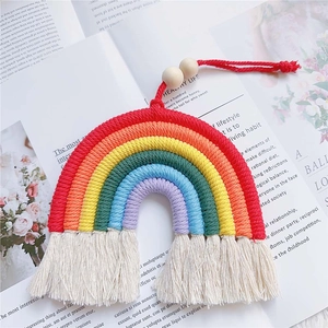 Close-up of a 7-color handmade woven rainbow car hanging with cotton tassels and wooden beads