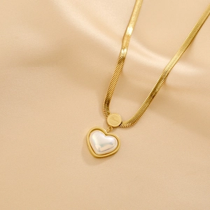 Gold snake chain necklace with pearl heart pendant and engraved Love charm on silk