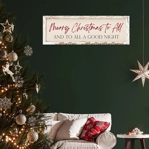 Close-up of wooden Merry Christmas wall plaque hanging in a cozy holiday living room decor