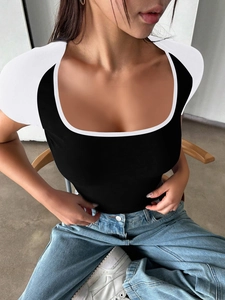 Detail view of a slim-fit Y2K T-shirt with white U-neck contrast on black fabric