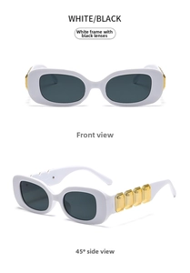 Close-up of white frame sunglasses with dark gray lenses and gold metal accents