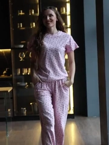 Detail of pink polka dot pajamas featuring short sleeves and soft breathable fabric