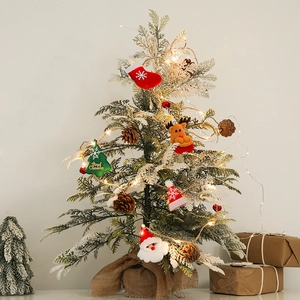 LED Christmas garland with pine cones and plush ornaments on a snow-covered tree