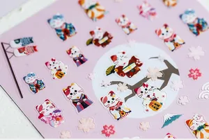 Detail of 5D nail art stickers featuring Japanese lucky cats, cherry blossoms and waves