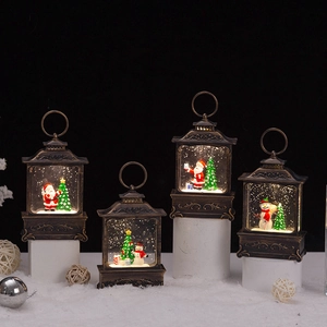 Macro shot of vintage bronze Christmas lanterns with light-up snow globe scenes
