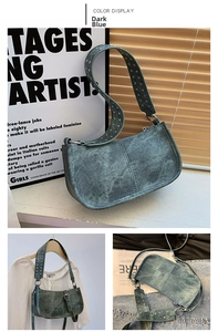 Close-up of dark blue denim shoulder bag featuring silver rivets and retro buckle strap
