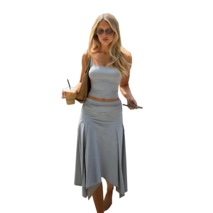 Women's grey two-piece set featuring one-shoulder crop top and asymmetrical ruffle maxi skirt