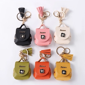 Mini faux leather earbud bag keychains in multiple colors with tassels and metal hooks