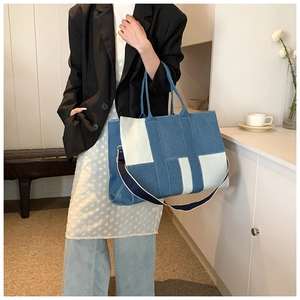 Detail of the blue and beige patchwork denim tote bag with adjustable shoulder strap