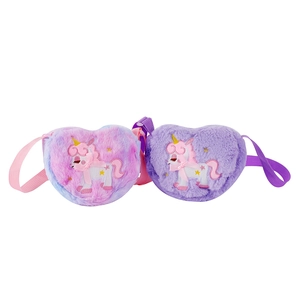 Detail of plush heart-shaped crossbody bags featuring unicorn embroidery and bow accents