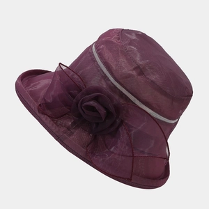 Detailed view of dark purple sun hat with elegant mesh flower and breathable lace texture