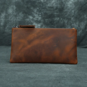 Close-up of brown crazy horse leather wallet with vintage texture and zipper detail