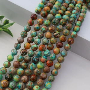 Vue détaillée des perles rondes en pierre d'empereur pour la création de bijoux DIY