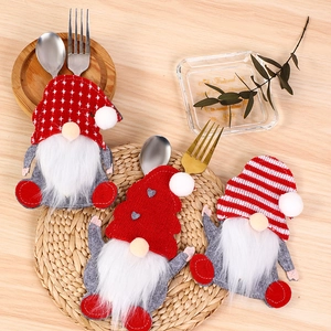Detailed view of three festive gnome cutlery holders made of soft felt for Christmas tables