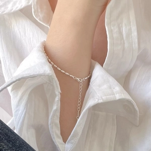 Minimalist S925 sterling silver beaded bracelet with adjustable chain on a woman's wrist