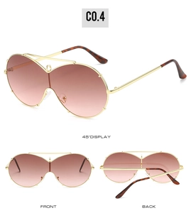 Detailed views of oversized gold metal sunglasses with brown gradient lenses