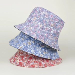 Detailed view of three floral bucket hats in pink, blue and orange pastoral patterns