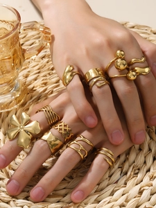 Detail of 18k gold plated petal and palm rings styled in a layered fashion set