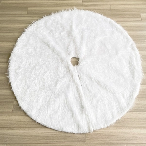 Detailed close-up of fluffy white faux fur Christmas tree skirt on light wood floor
