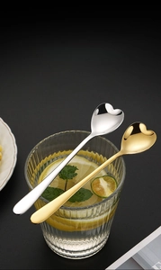 Close-up of heart-shaped stainless steel spoons with polished mirror finish and sleek design