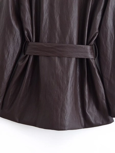 Detailed back view of a chocolate brown faux leather trench coat with matching belt buckle