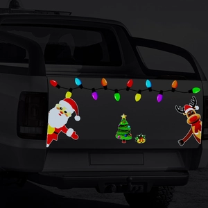 Reflective Christmas car decals with Santa, reindeer and lights on a dark pickup tailgate