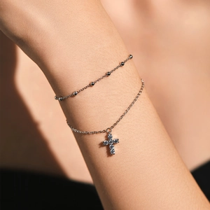 Double-layered 925 sterling silver beaded bracelet with shimmering crystal cross pendant
