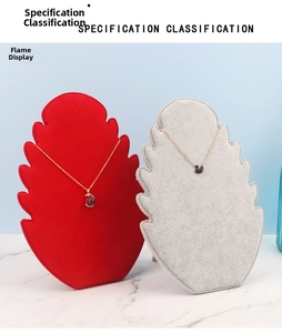 Close-up of flame-shaped velvet necklace display boards in red and grey colors