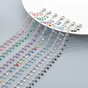 Dettaglio di perline smaltate colorate su catenine per cavigliere in acciaio inossidabile