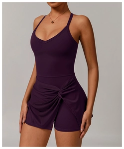Detail of cross-knot design on deep purple tennis dress with slimming waist effect