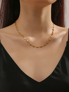 Detailed view of a gold-plated titanium necklace with small 3D heart-shaped pendants