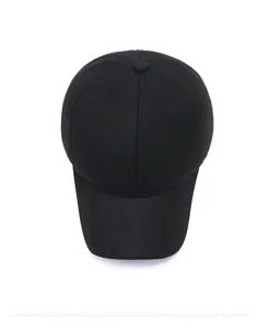 Overhead view of a black baseball cap with silver metal logo and twill cotton fabric