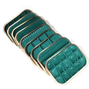 Detail of luxury green velvet jewelry trays with gold frames for organized storage