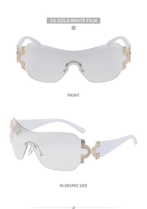 Detail view of white and gold Y2K sunglasses with luxury rhinestone hinges and shield lens