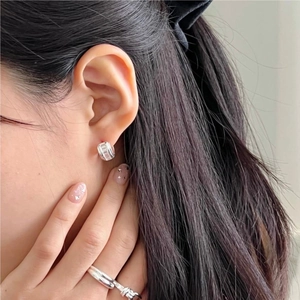 Detail view of 925 sterling silver hoop earrings with rectangular cubic zirconia