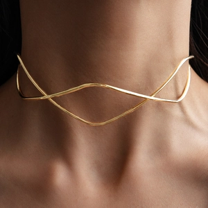 Close-up of a minimalist gold wavy choker with double-layered intersecting metal lines