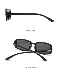 Detail view of black rectangular sunglasses featuring gold T-shaped metal hinge accents