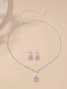 Detail of silver bridal jewelry set with pink pear-cut crystals and sparkling rhinestones