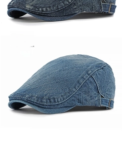 Detail of medium blue washed denim flat cap with adjustable metal side buckle and texture