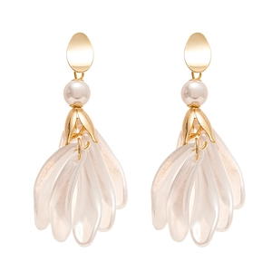 Boucles d'oreilles pétales vintage avec métal doré et perles sur fond blanc épuré