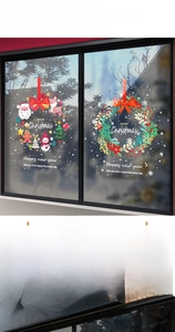 Detailed Christmas window decals showing Santa and reindeer designs on a glass surface
